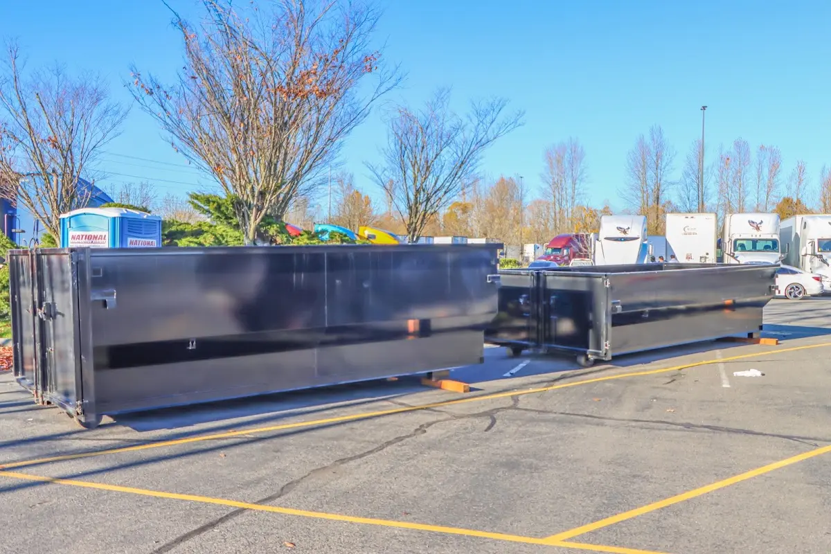 Professional dumpster rental service with roll-off container on residential driveway in La Joya